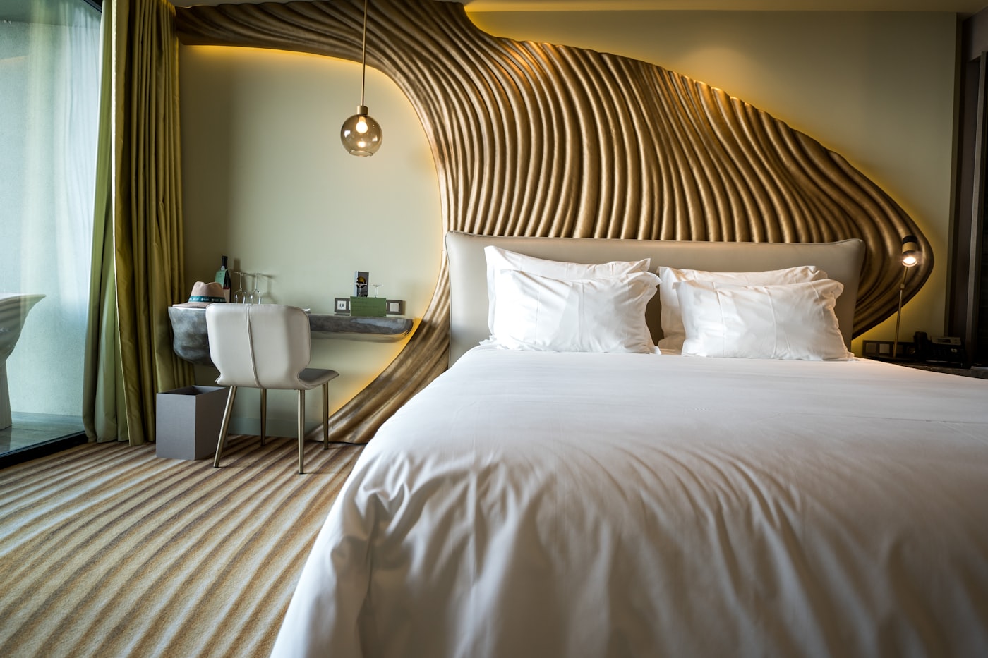 Show unit: bedroom with sculptural gold headboard